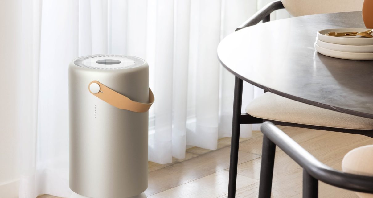 modern molekule air purifier with faux leather handle next to dining room chairs