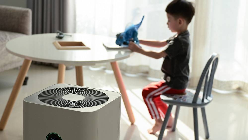 boy playing near air purifier