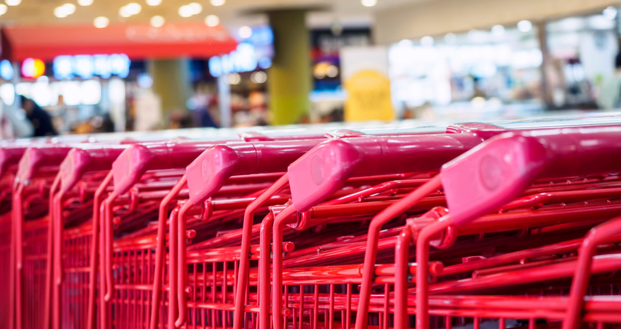 close up image of red shopping carts in a store