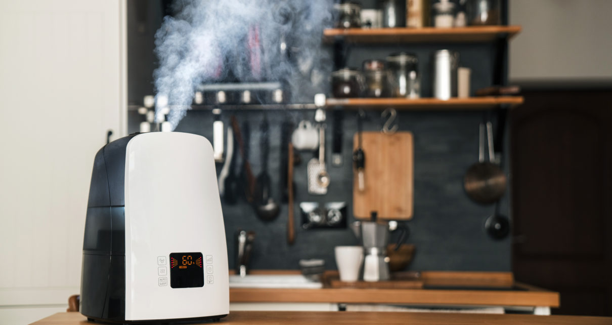 warm mist humidifier in focus on industrial kitchen counter