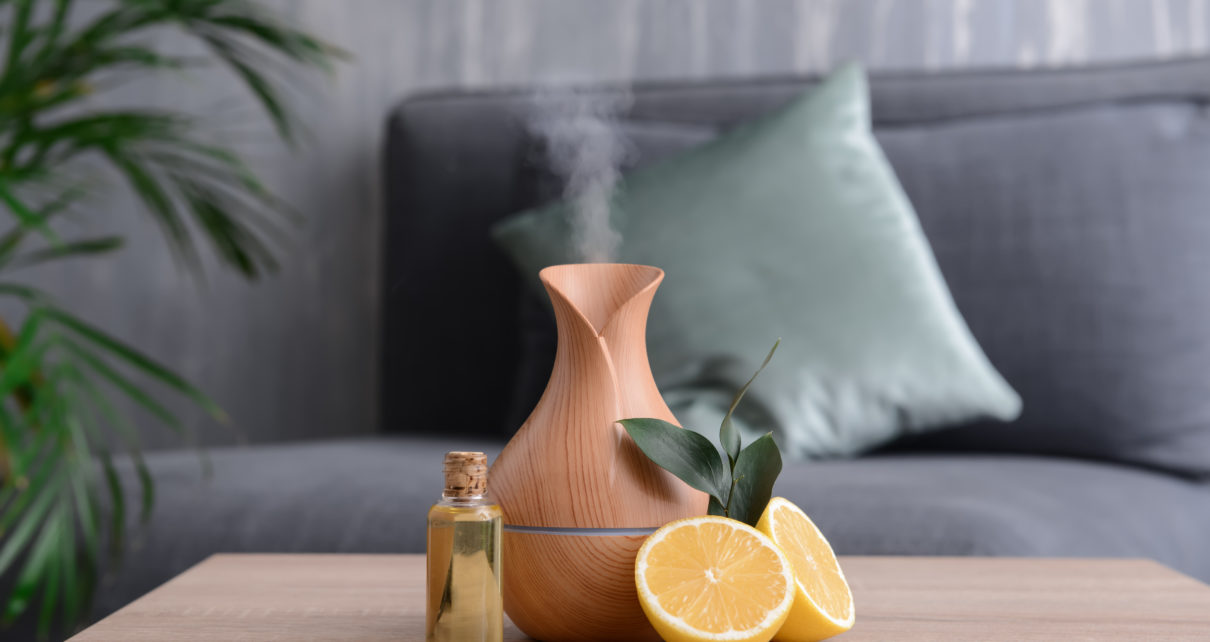 essential oill diffuser with halved lemon and bottle of essential oil