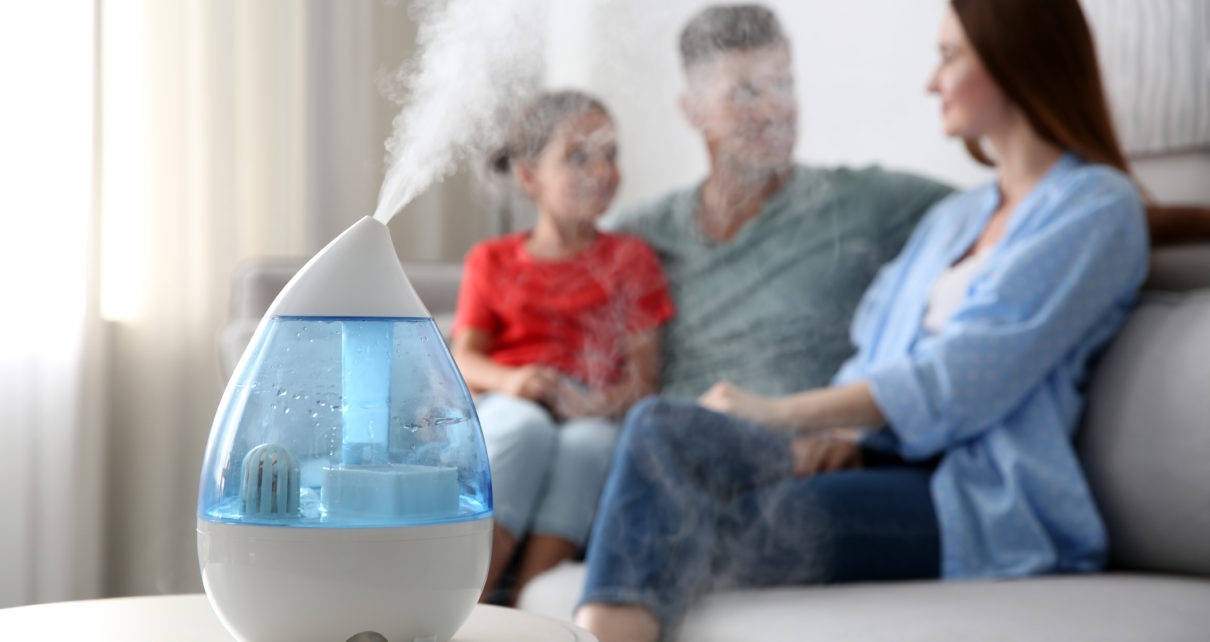 vicks humidifier on table in front of family sitting on couch
