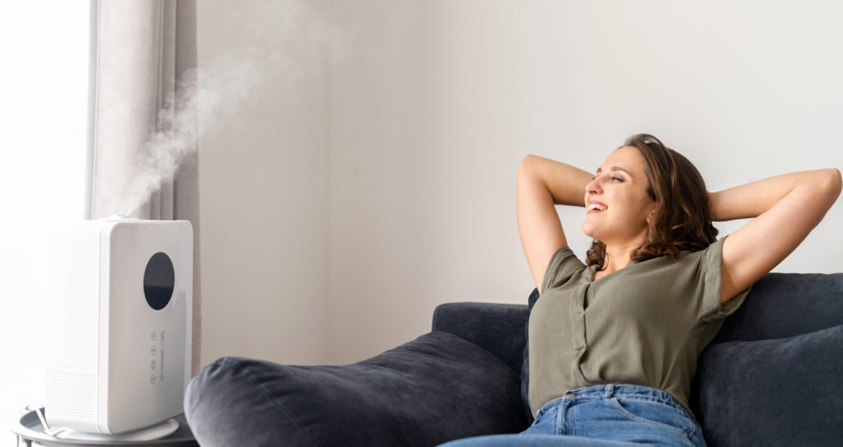 woman breathing relaxing on couch easy after using humidifier for cough in living room