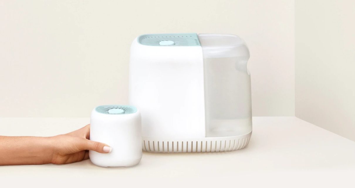womans hand holding small canopy humidifier next to full sized canopy humidifier